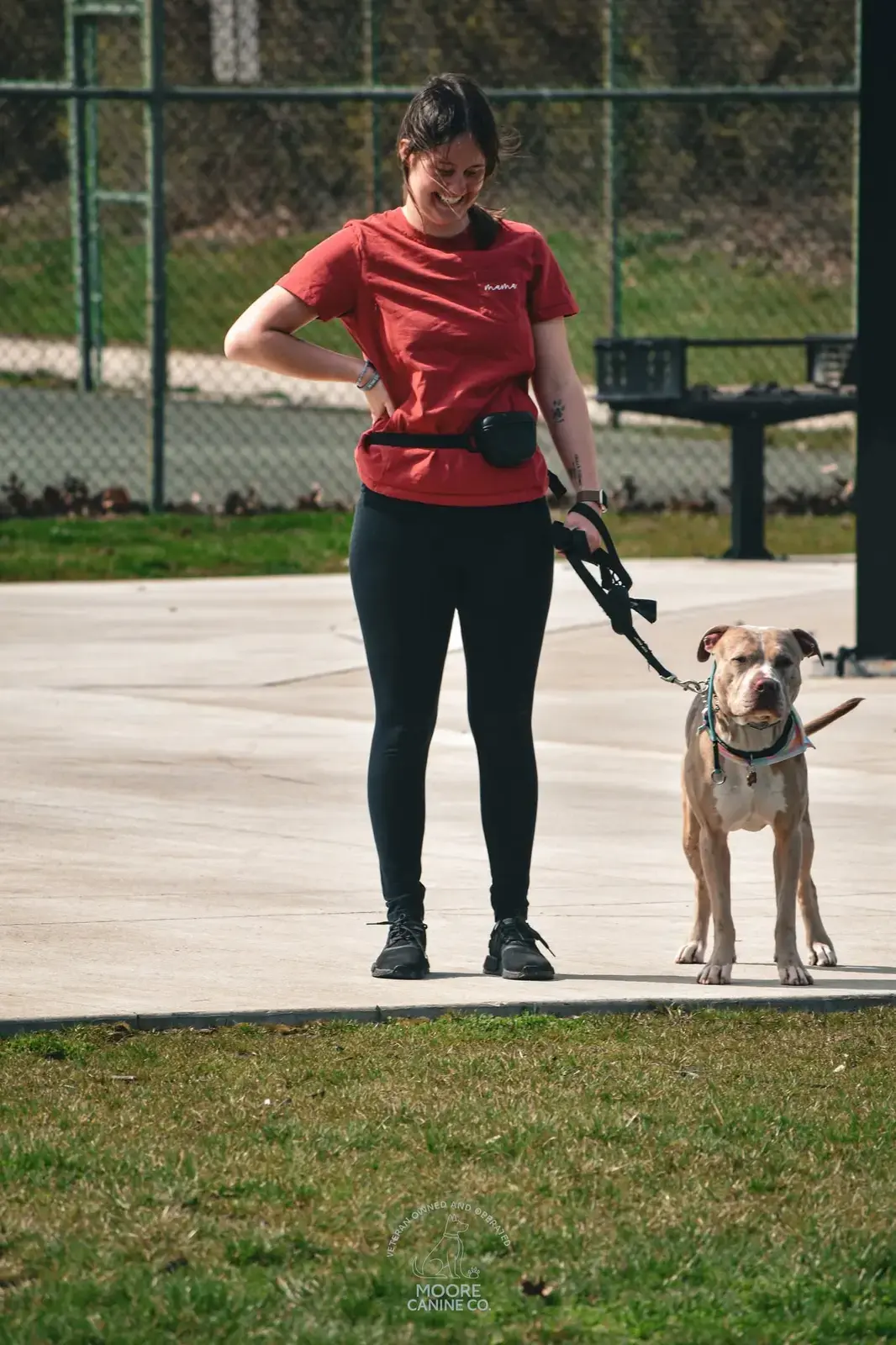 A smiling owner walking her dog